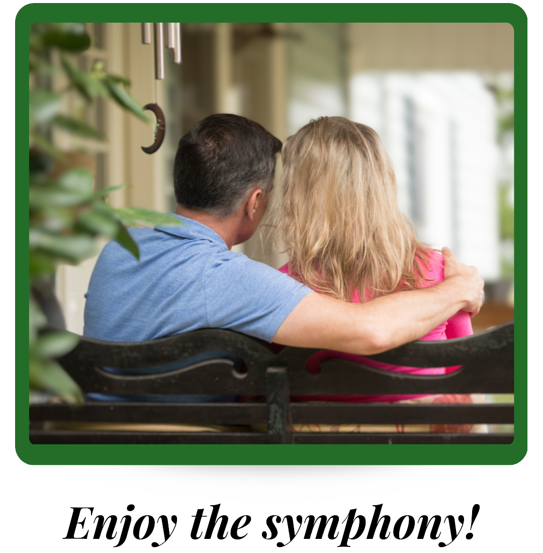 A couple sits on a porch swing listening to the symphony of cicadas.